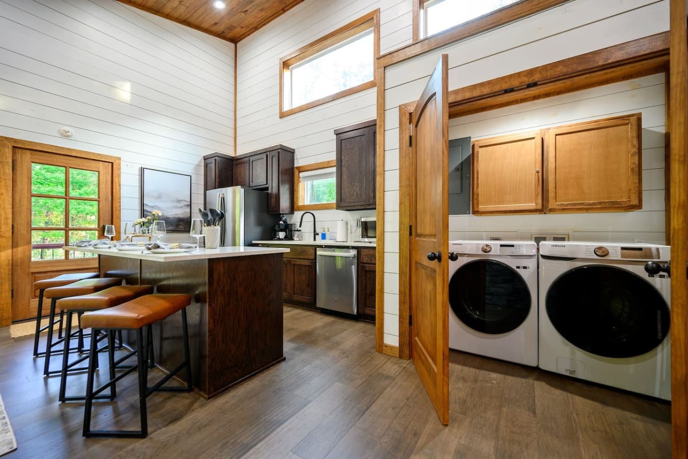 The laundry room's tucked away nice and clean with those sleek front-loaders, so you can actually keep up with laundry during your stay instead of coming home to a pile of dirty clothes.