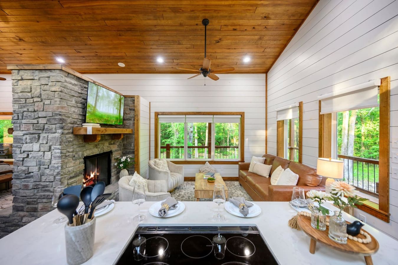 Cooking dinner while the fire crackles behind you and your whole crew spreads out across the living room—this is the setup that makes everyone actually want to hang out together instead of disappearing to different corners.