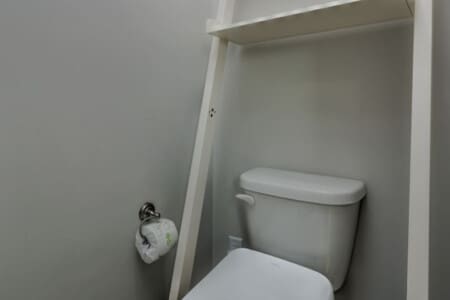Gotta love a no-fuss bathroom that's clean, functional, and ready to go—complete with those handy shelves above the toilet for all your essentials.