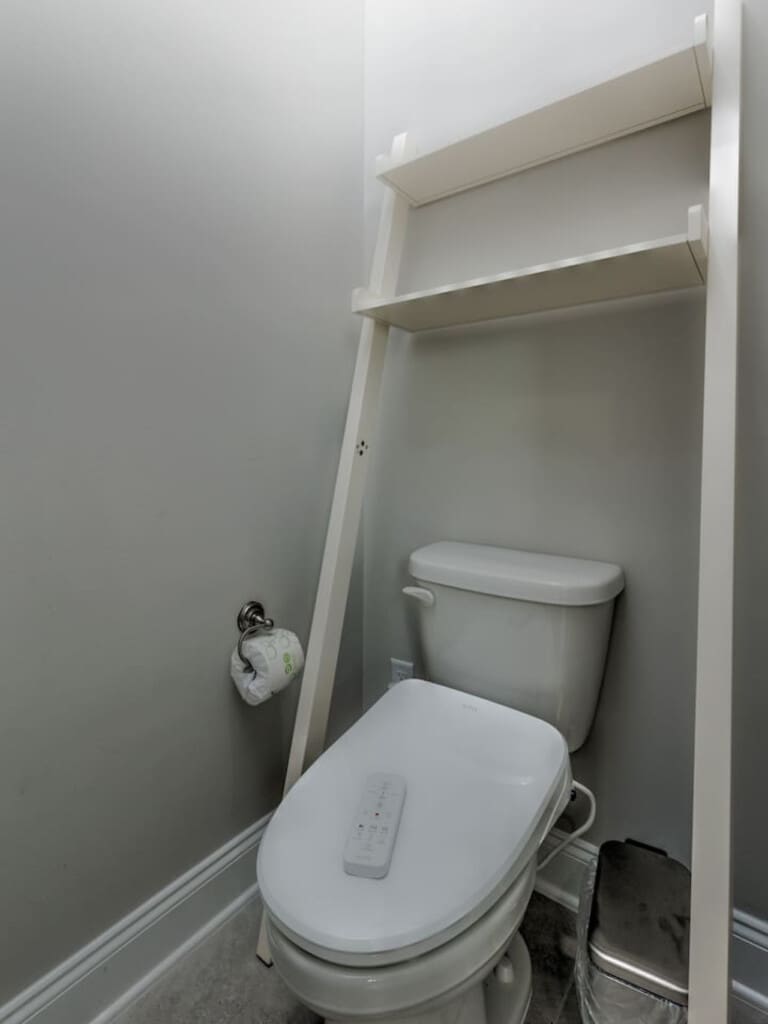 Gotta love a no-fuss bathroom that's clean, functional, and ready to go—complete with those handy shelves above the toilet for all your essentials.