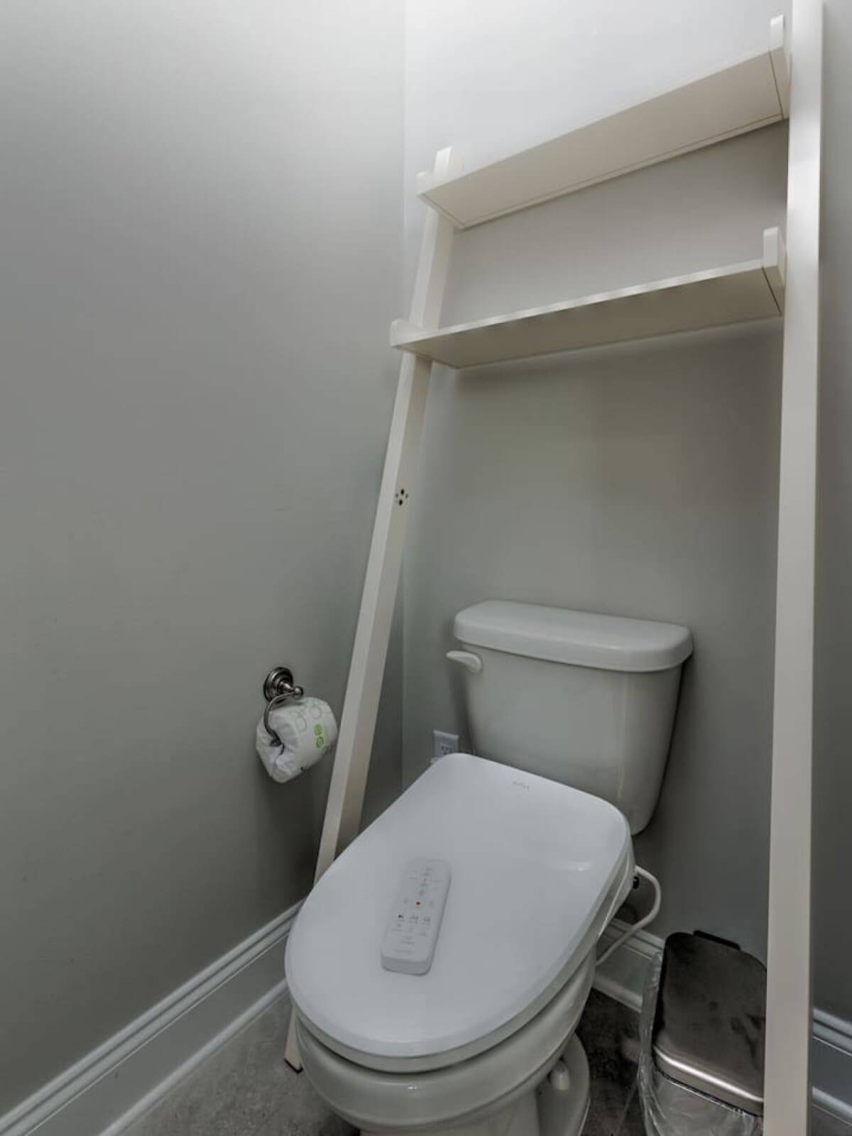 Gotta love a no-fuss bathroom that's clean, functional, and ready to go—complete with those handy shelves above the toilet for all your essentials.