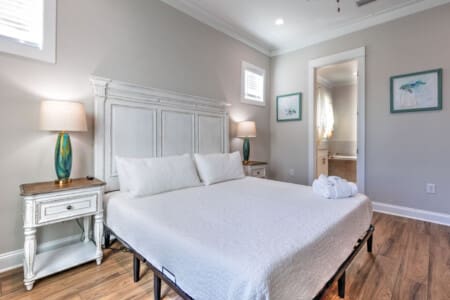 This serene master bedroom nails that peaceful coastal retreat vibe with its clean aesthetic, soft lighting, and direct access to the ensuite—basically the perfect setup for actually getting some quality rest.