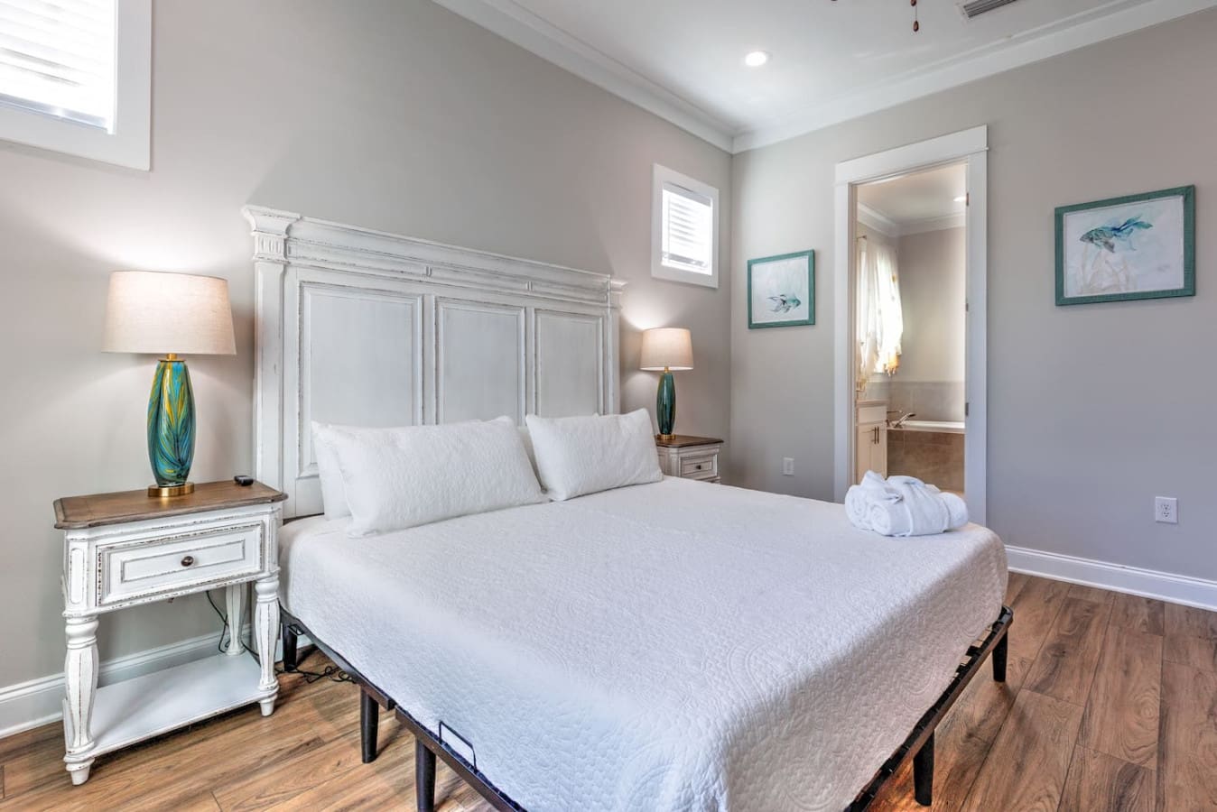 This serene master bedroom nails that peaceful coastal retreat vibe with its clean aesthetic, soft lighting, and direct access to the ensuite—basically the perfect setup for actually getting some quality rest.