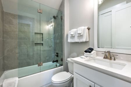 This bright, clean bathroom has everything you need to get ready in style, with a spacious vanity, that gorgeous walk-in shower with the glass enclosure, and plenty of fluffy towels within arm's reach.