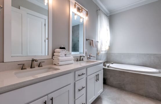 This bathroom is basically a dream for getting ready—that massive double vanity gives you and your travel buddy plenty of elbow room, the walk-in shower is legitimately spa-quality, and the natural light streaming through makes the whole space feel bright