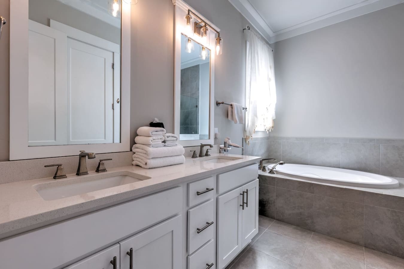 This bathroom is basically a dream for getting ready—that massive double vanity gives you and your travel buddy plenty of elbow room, the walk-in shower is legitimately spa-quality, and the natural light streaming through makes the whole space feel bright