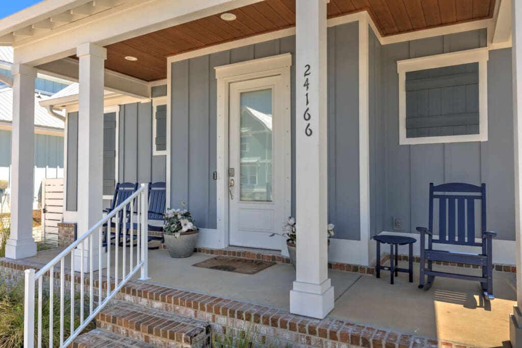 This covered porch is the perfect spot to settle in with a good book or just watch the world go by—those navy rockers are basically calling your name.