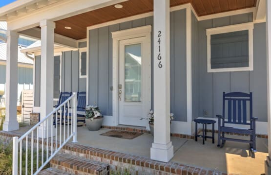 This covered porch is the perfect spot to settle in with a good book or just watch the world go by—those navy rockers are basically calling your name.
