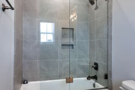 This spa-like bathroom with its sleek walk-in shower, crisp white subway tile, and that perfect natural light basically makes you feel like you're getting a mini-vacation every time you step in.