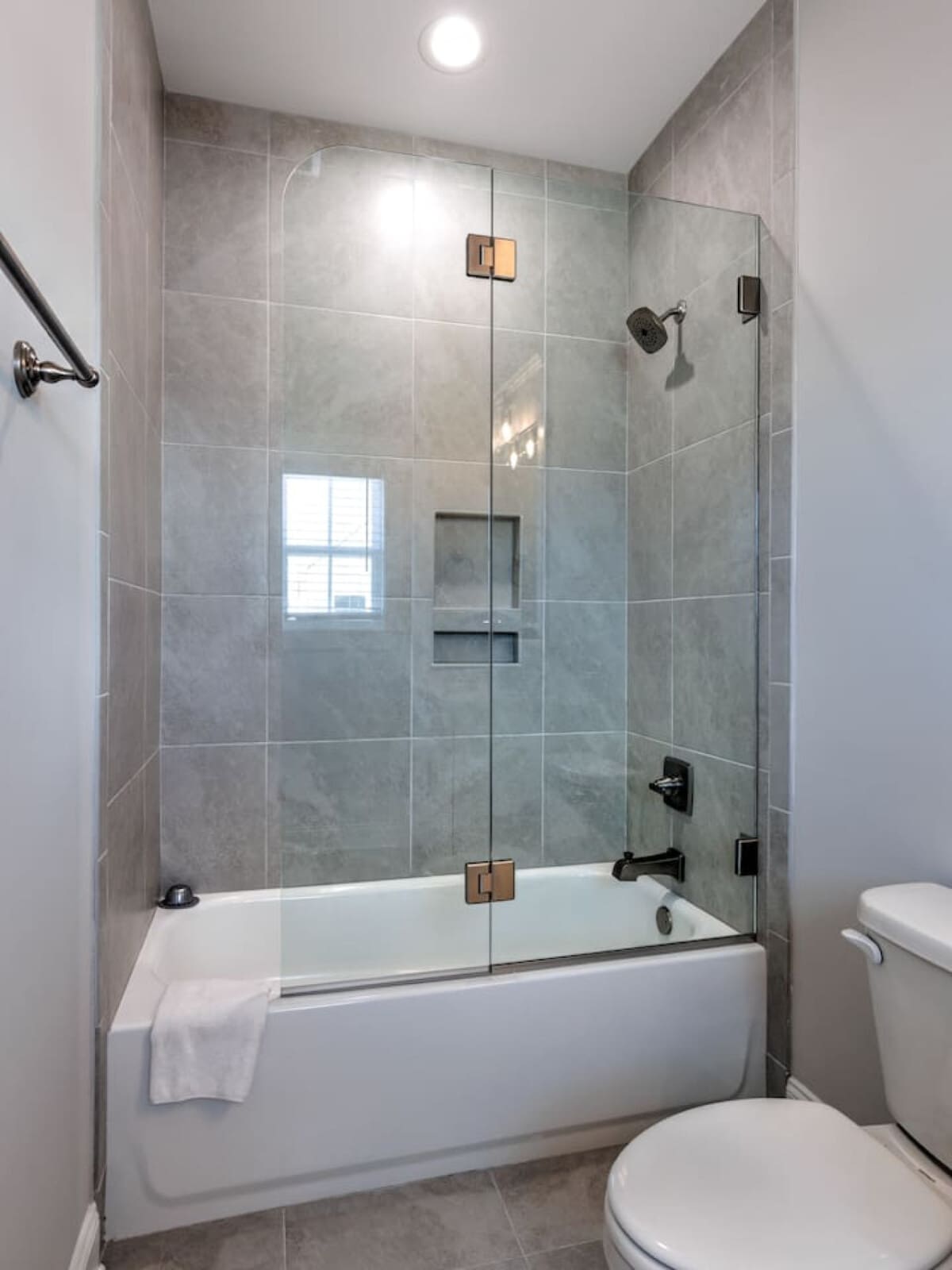 This spa-like bathroom with its sleek walk-in shower, crisp white subway tile, and that perfect natural light basically makes you feel like you're getting a mini-vacation every time you step in.