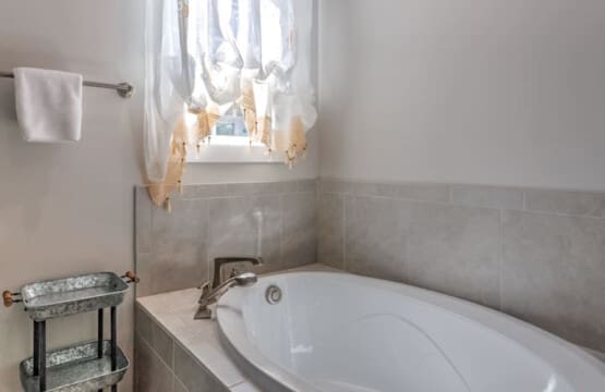 This soaking tub with its dreamy window view and that charming tie-up curtain is basically calling your name after a long day of exploring.