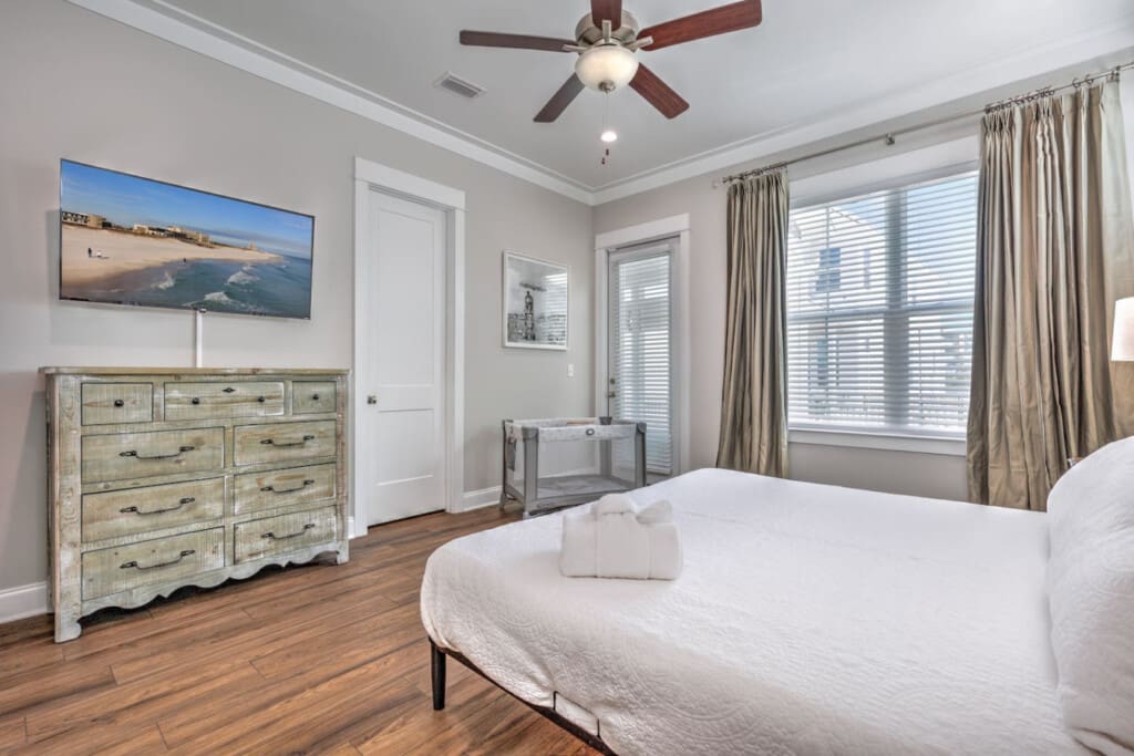 This master bedroom is all about that relaxed beach house energy with the whitewashed dresser, tons of natural light, and plenty of space to actually spread out and breathe.