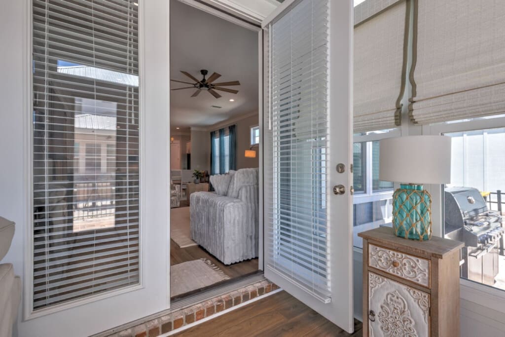 These sliding glass doors with those practical built-in blinds give you the perfect way to control the light and privacy while still keeping that seamless connection between your bedroom and the rest of the space.