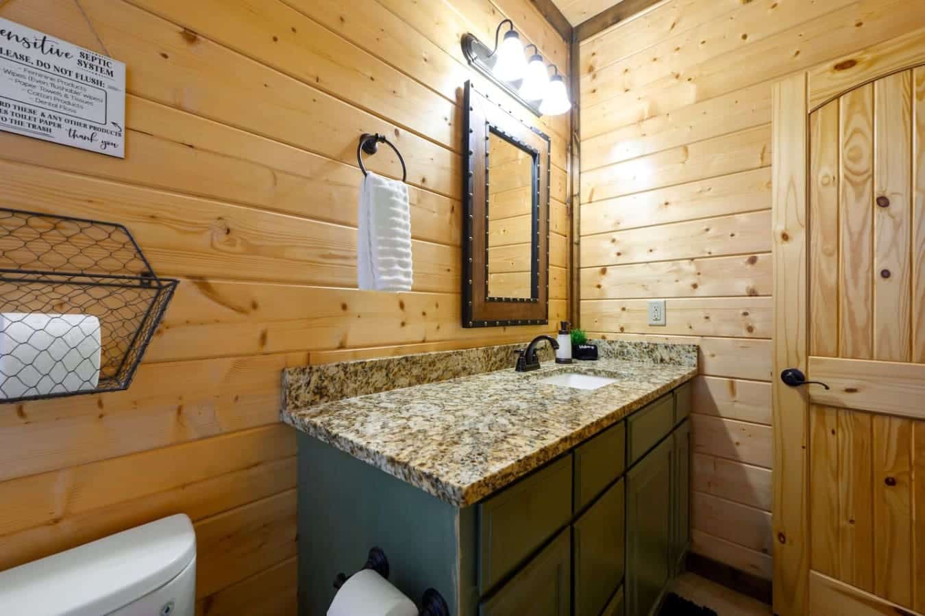 This bathroom's got you covered with double sinks so nobody's hovering while someone else takes forever, granite countertops that actually look good, and a framed mirror situation that doesn't make you squint.