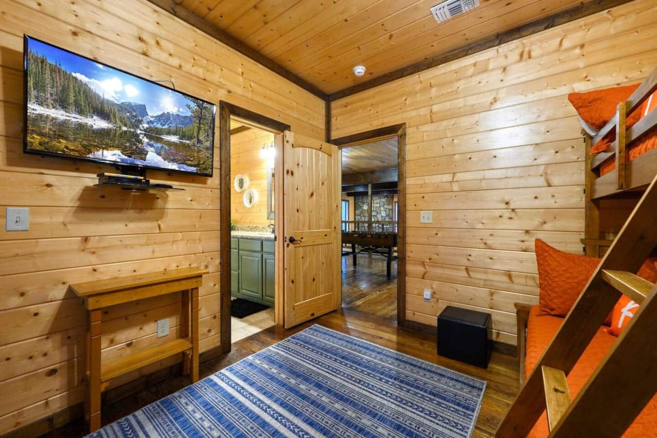 This main living area is basically where everyone ends up hanging out—tons of natural light, a TV if you want it, wood beams overhead, and enough room that you're not all crammed onto one couch arguing about what to watch.