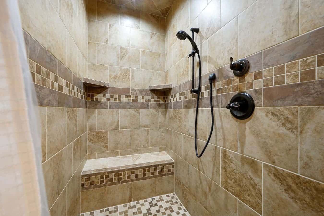 This shower's got the whole setup—rainfall showerhead, a handheld wand so you can actually reach everywhere, and those built-in benches are clutch when you just need to sit and let the hot water do its thing.