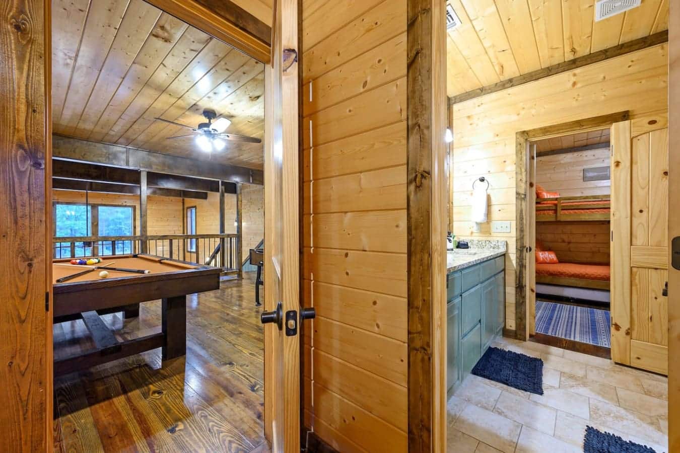 This game room and bathroom hallway combo is basically where everyone splits up to do their own thing—pool table on one side, shower situation on the other, and enough space that nobody's waiting around for anyone else.