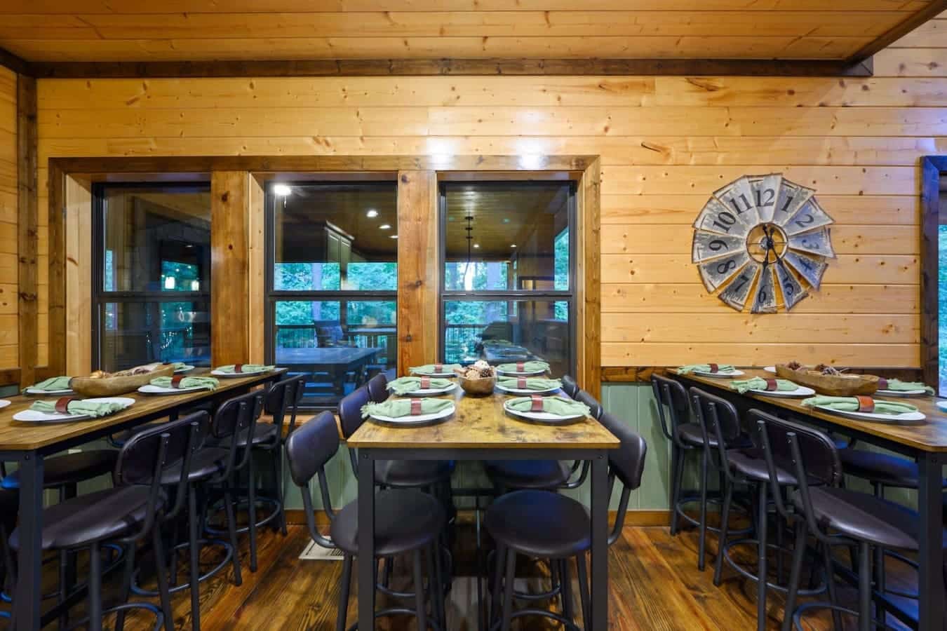 This dining room is basically where the whole crew gathers to actually sit down together, with those giant windows framing the trees so you're eating with a view that beats any restaurant in town.