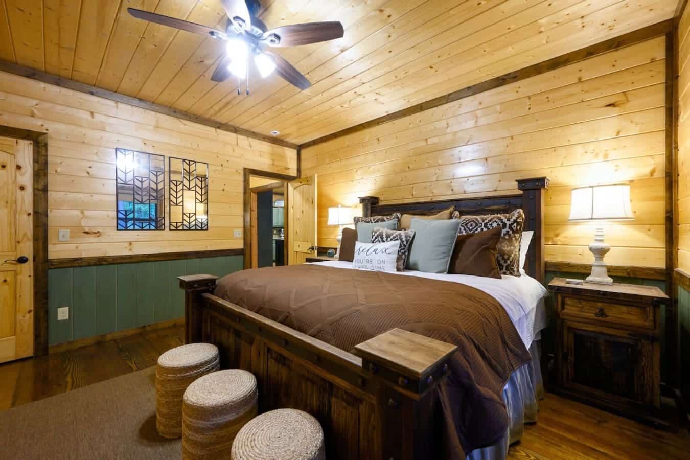 This master bedroom's got all the wood-cabin coziness you're looking for, but with enough space and that king bed situation that actually lets you sprawl out and enjoy the view without feeling cramped.