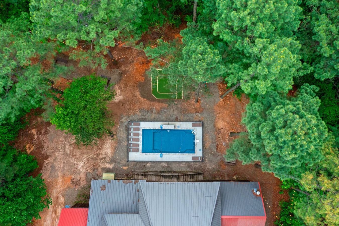 Surrounded by nothing but trees and your own private pool, this is the kind of backyard where you can actually relax without feeling like someone's going to walk by.