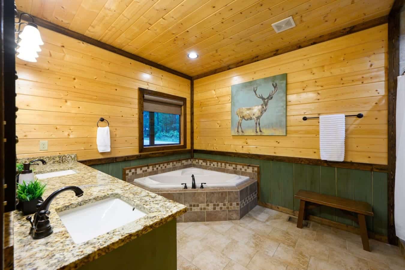 This bathroom's basically a spa moment waiting to happen with that corner soaking tub, dual sinks so nobody's fighting over counter space, and enough wood-cabin charm to make you forget you're supposed to be roughing it.