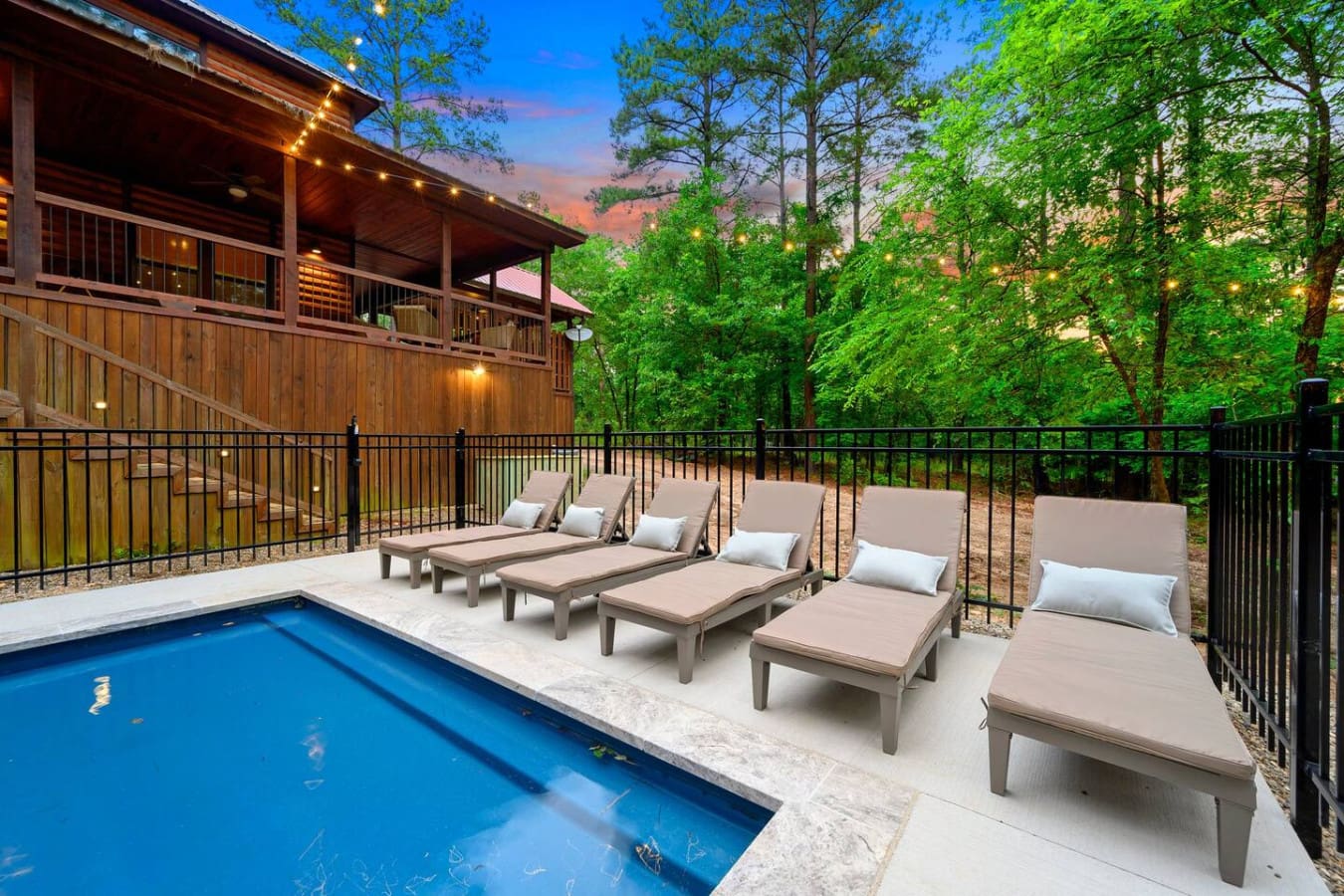 Line up your loungers and actually use them, because this pool area is basically built for doing absolutely nothing while surrounded by trees and twinkling lights.