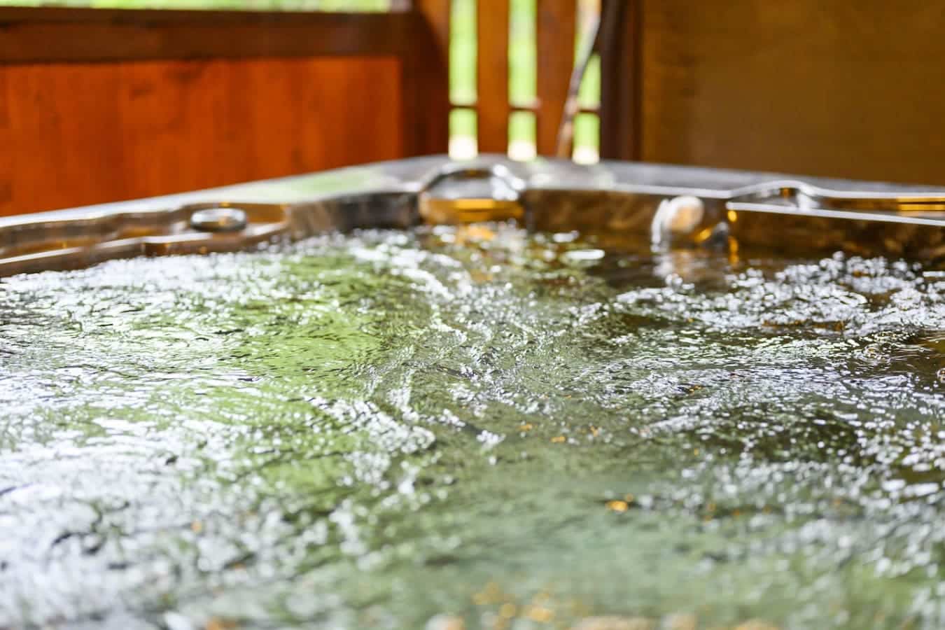 Looks like someone forgot to clean out the hot tub before you got there, but honestly the mineral buildup and floating stuff just adds to the rustic vibe.