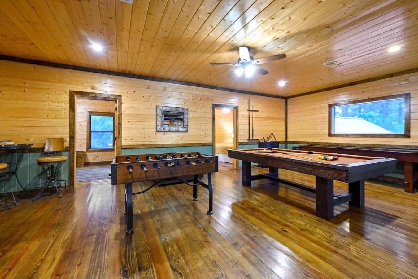 This game room's basically got everything—foosball, pool table, big screen, and enough space that everyone can actually play at the same time without bumping elbows.