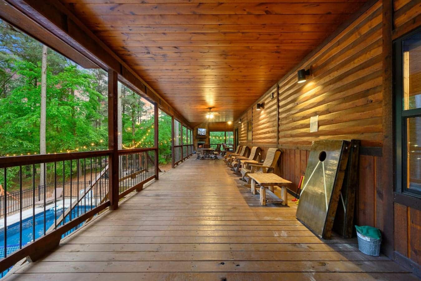 This covered porch is basically a whole other room—long enough to actually walk around in, lit up at night, and with enough seating that your group can spread out without feeling cramped.