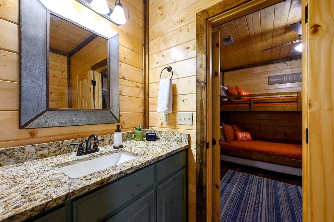 This bathroom's got double sinks so nobody's fighting over counter space, granite that actually handles splashes without looking messy, and a mirror big enough that you're not doing your whole routine in a postage stamp.