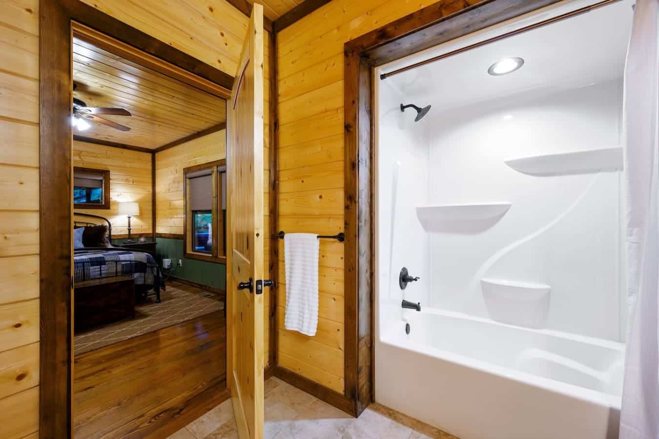 This bathroom's got that cabin-lodge vibe going with the wood walls and soaking tub, but then they threw in a totally modern walk-in shower so you don't have to choose between a soak and a quick rinse.