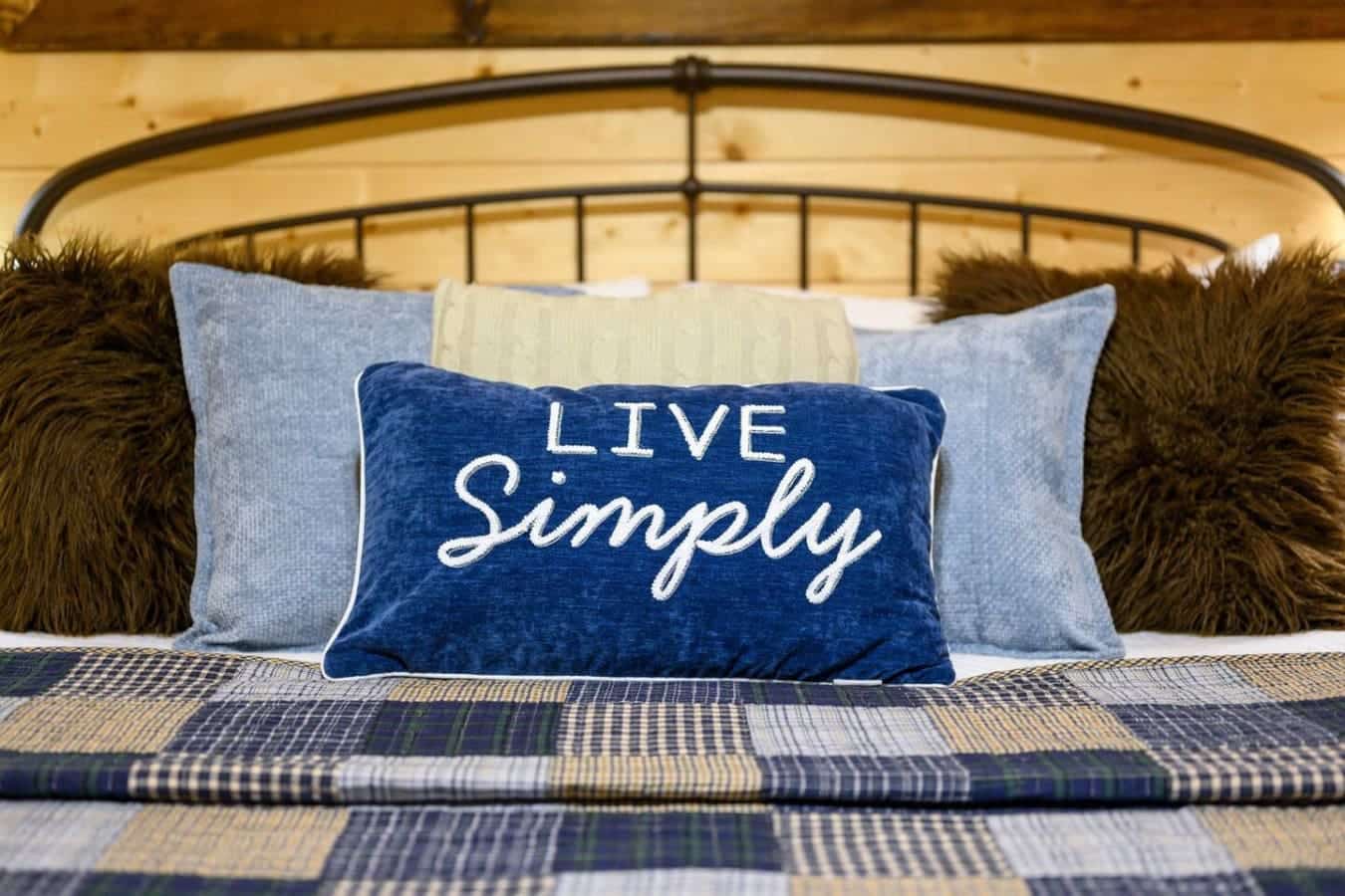 This bedroom's got that "live simply" energy with the cozy layers, the metal bed frame, and enough natural light that you'll actually want to sleep in instead of rushing out the door.