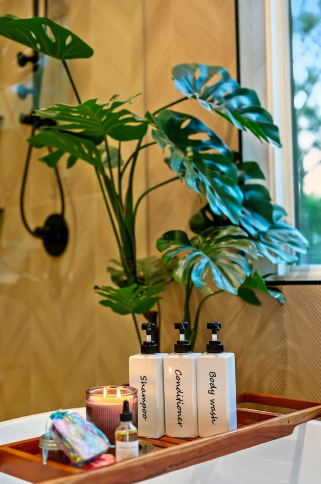 This corner of the rental is giving serious "me time" energy—fresh plants by the window, that candle glowing, and all the good self-care vibes you didn't know you needed on vacation.