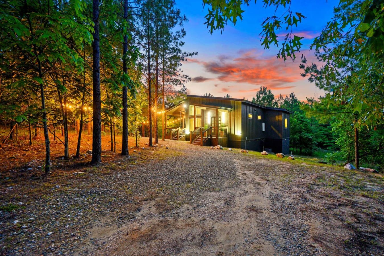 Imagine pulling up to your own glowing cabin nestled in the pines just as the sky turns that magical orange-and-pink, with nothing but forest silence and twinkling lights to welcome you.