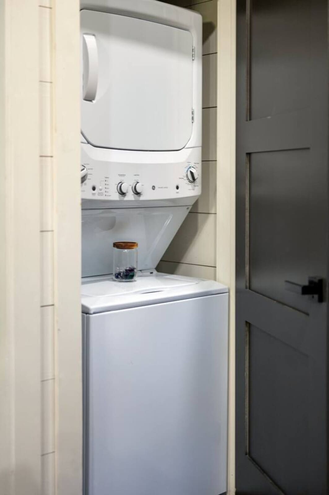 Looks like someone finally upgraded from the laundromat experience with this sweet stacked washer-dryer setup tucked right in the unit.