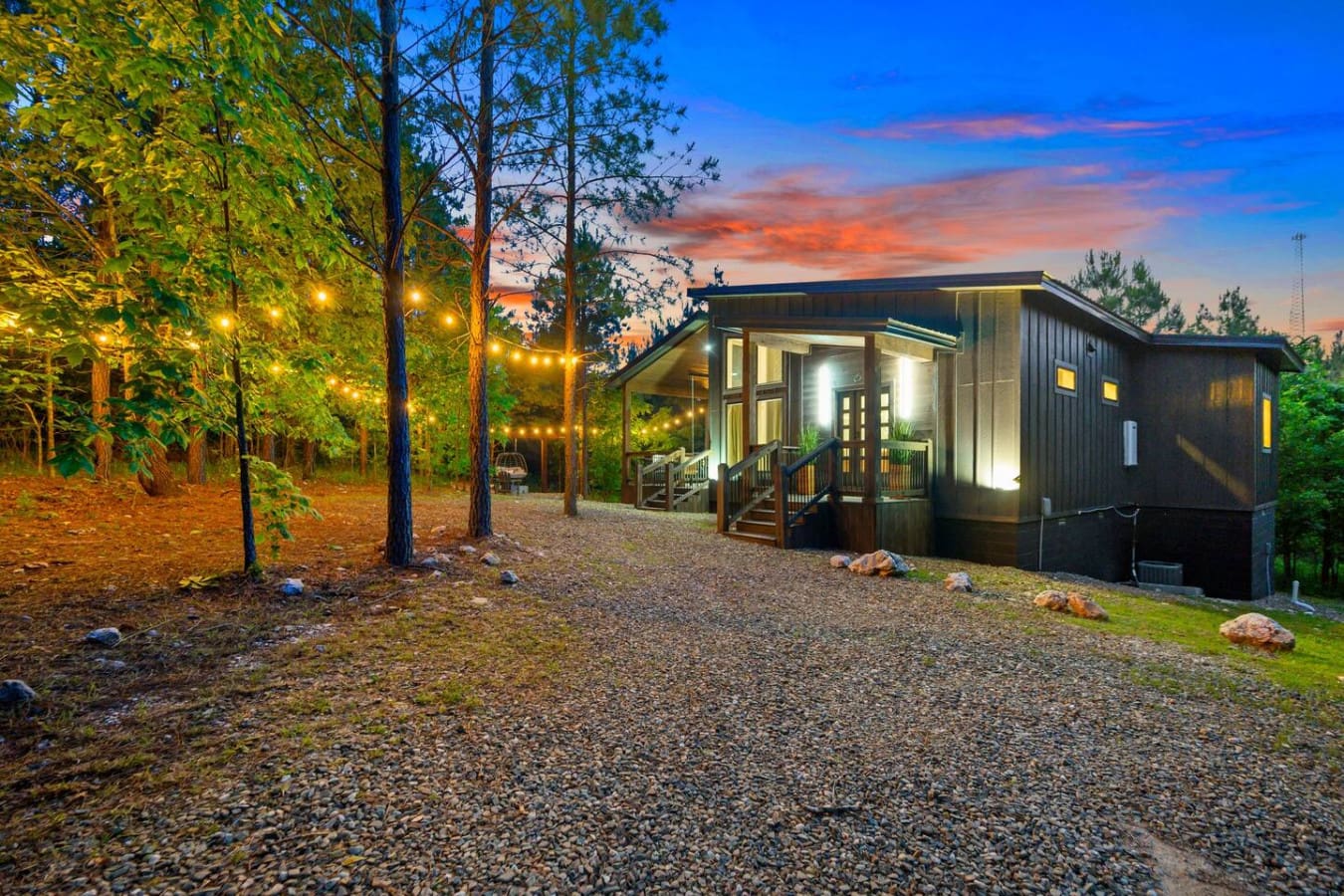 Picture this: you're standing in a forest clearing at twilight with your own glowing cabin retreat, twinkling string lights strung through the trees, and that perfect moment where the sky turns all those impossible shades of orange and pink—basically the