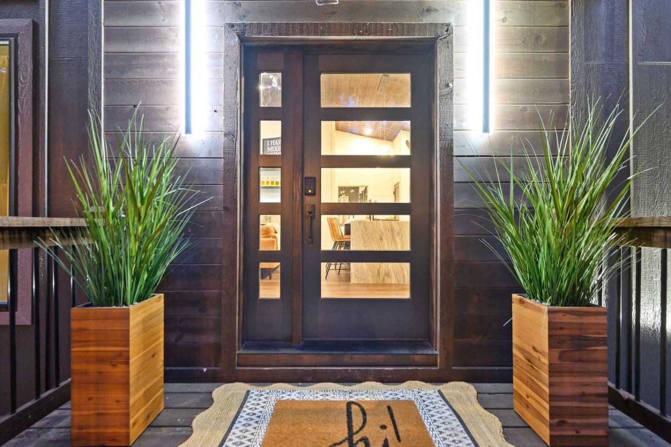 This entrance is basically the welcome you've been dreaming of—warm lighting, modern vibes, and those perfectly placed plants setting the tone for exactly the kind of retreat you need.