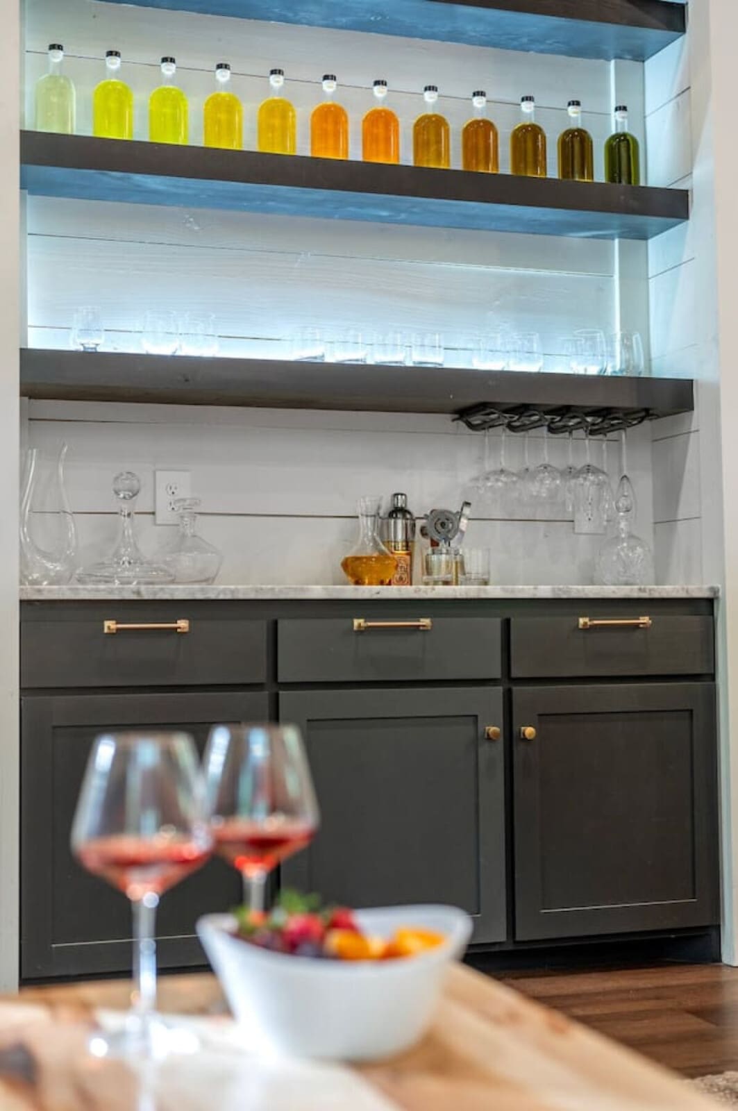 This home bar is basically begging you to get creative with whatever you bring, complete with a seriously impressive collection of oils and spirits on display.