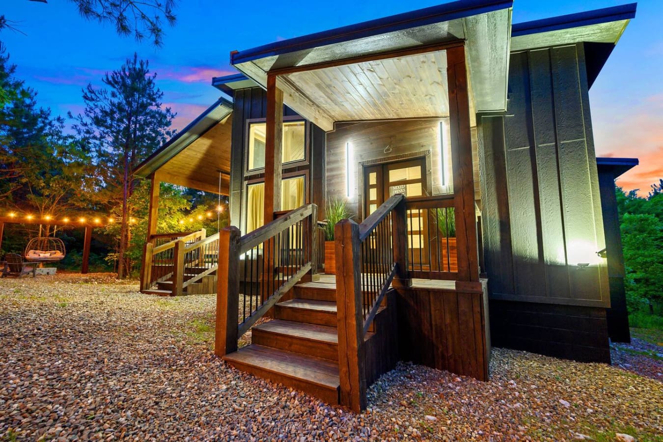 This modern glass-and-wood retreat glowing against the darkening forest feels like the kind of place where you actually forget to check your phone.
