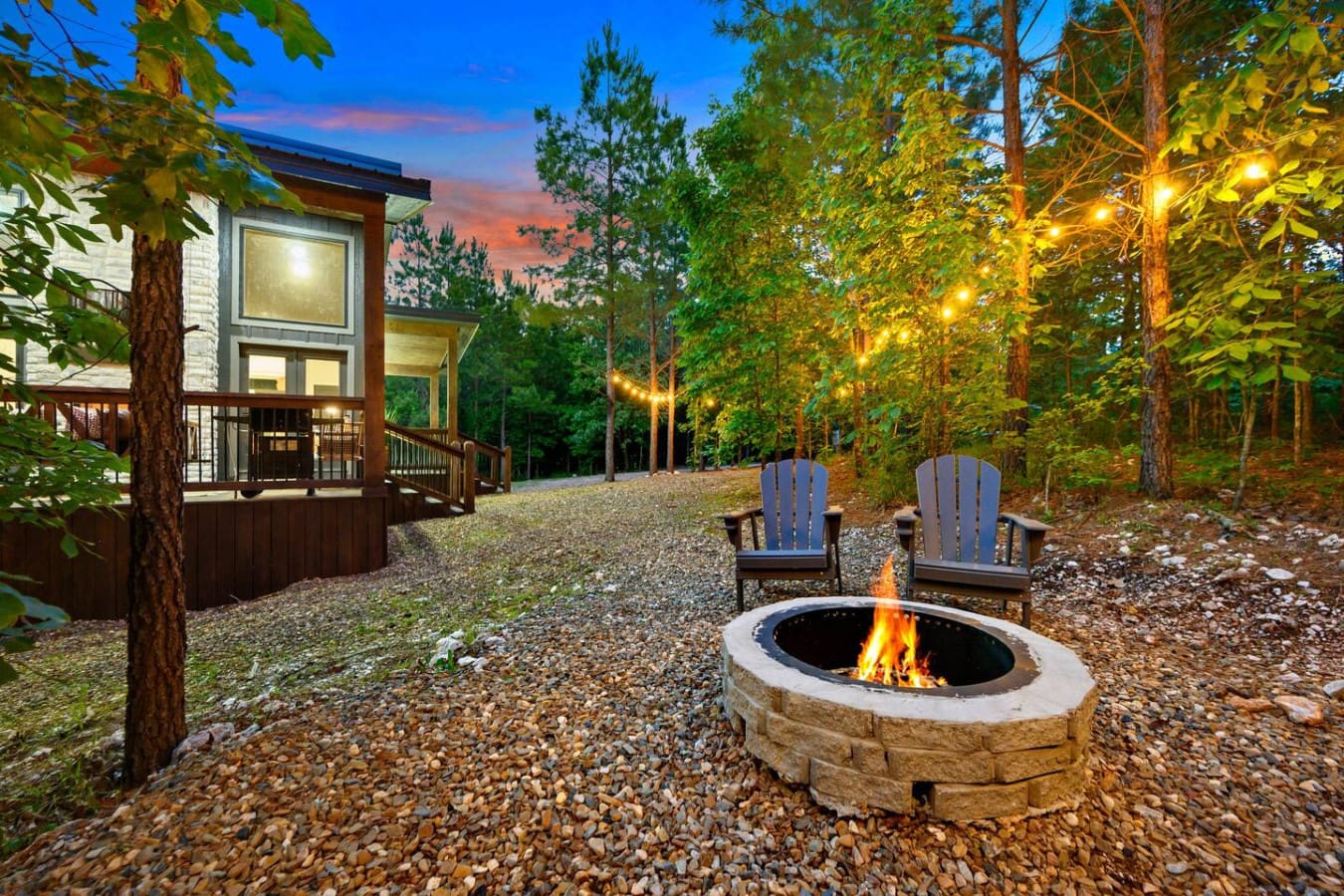 Nothing beats pulling up a chair to a crackling fire pit surrounded by towering pines and those golden lights twinkling through the trees as the sky turns that perfect shade of twilight blue.