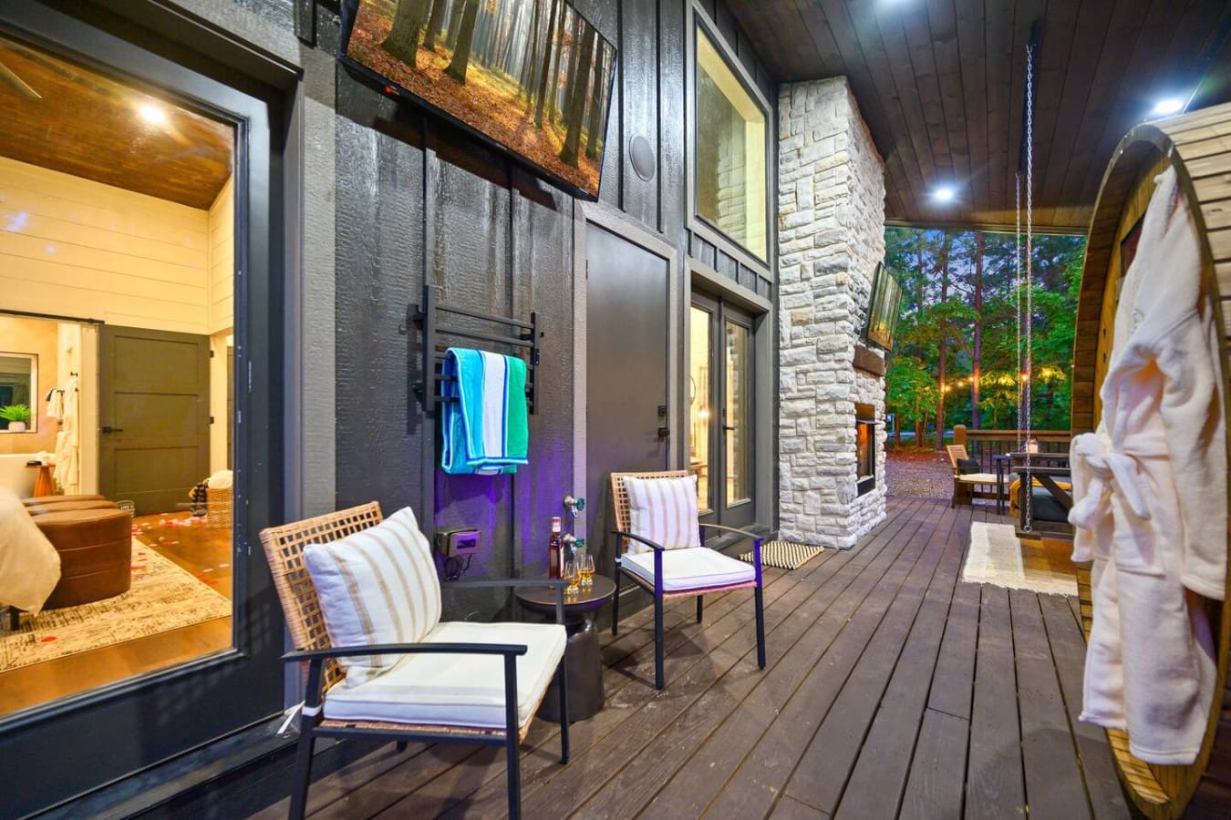 This covered deck is basically an outdoor living room that'll have you wondering why you ever leave—especially with that view of the trees and the cozy seating all set up for hanging out.
