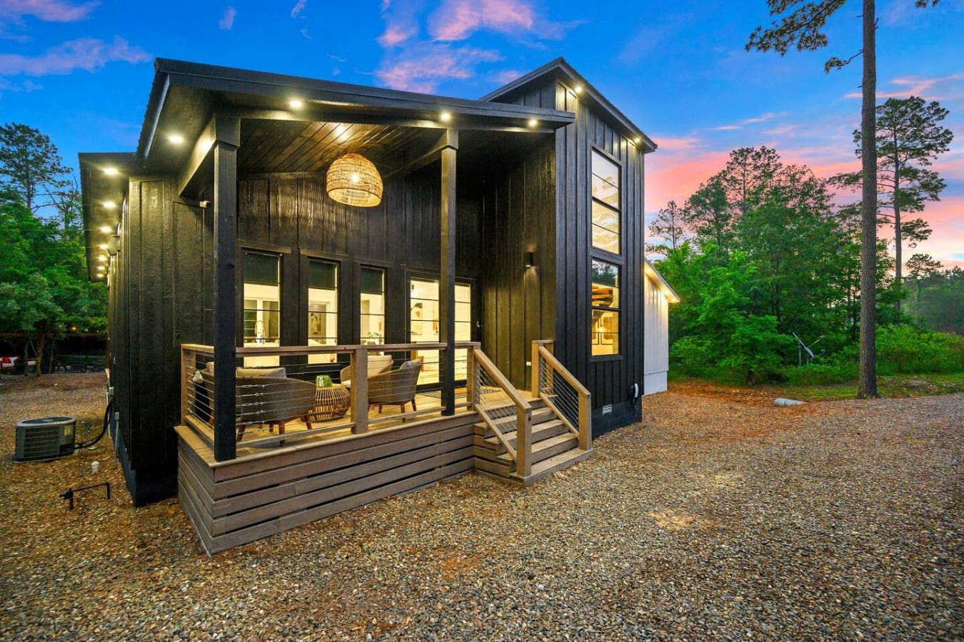 Evenings on the porch never looked so good—where modern design meets peaceful woodland views.