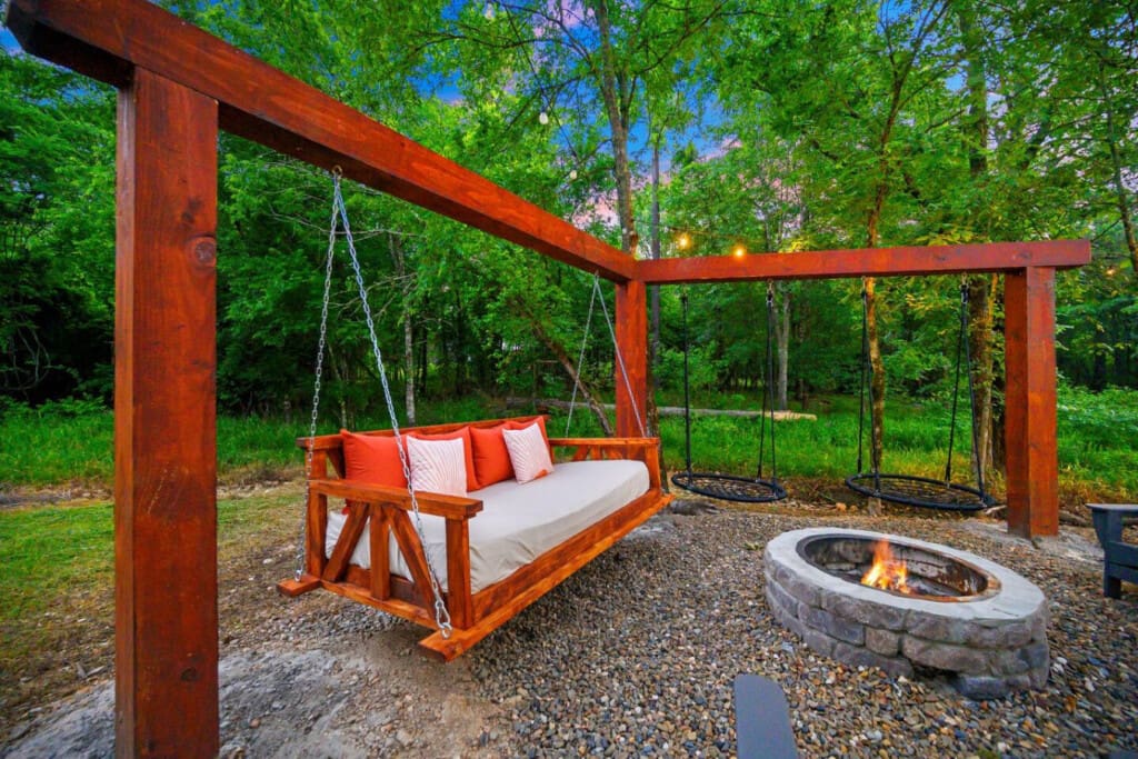 Sway into serenity—nothing beats cozying up by the fire on this dreamy swing under the trees.