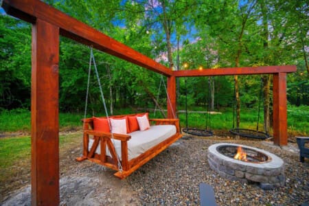 Sway into serenity—nothing beats cozying up by the fire on this dreamy swing under the trees.