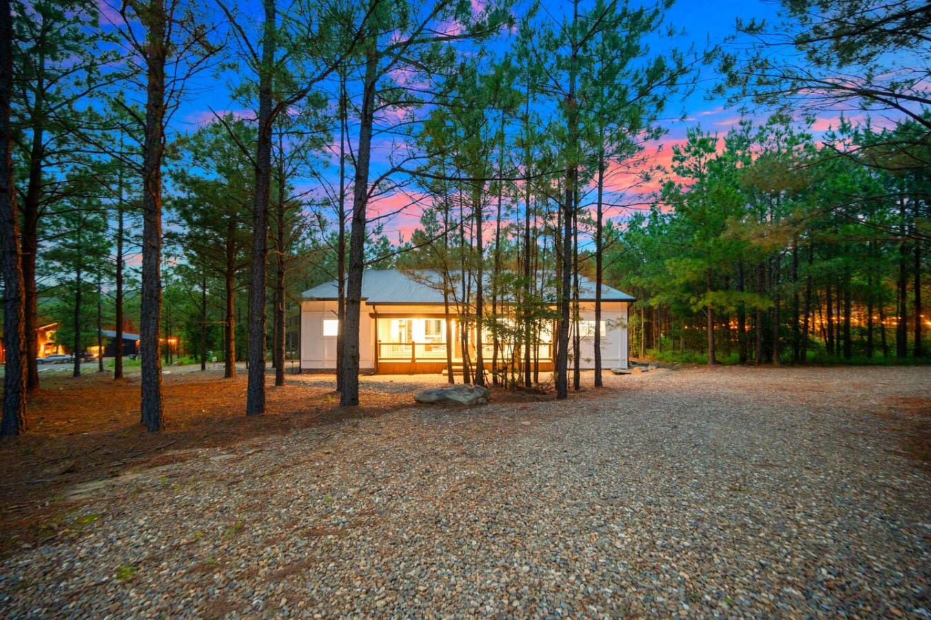 A peaceful retreat glowing with warmth, tucked beneath the pines.