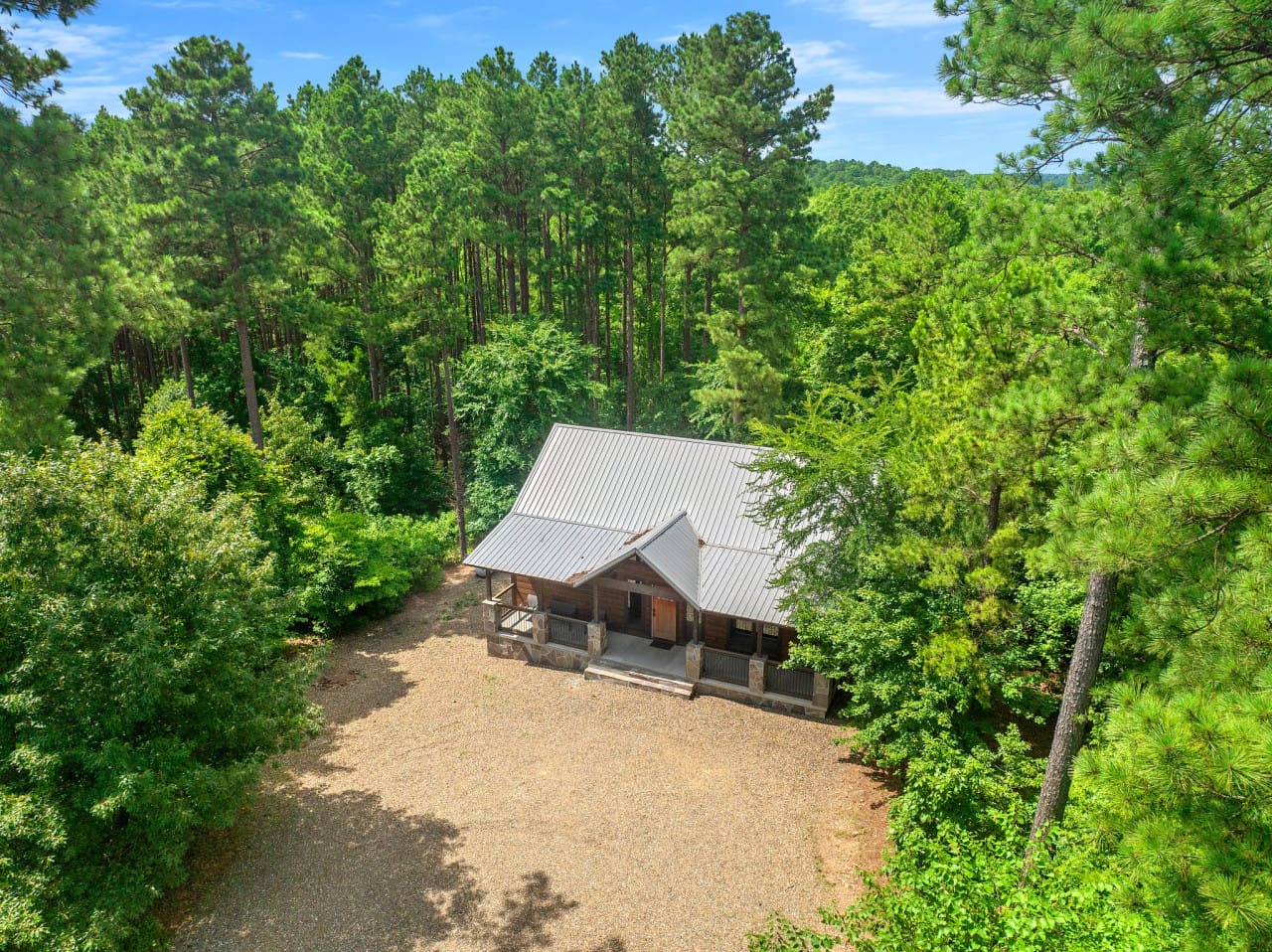 Drone perspective of your private retreat, surrounded by forest or mountains.