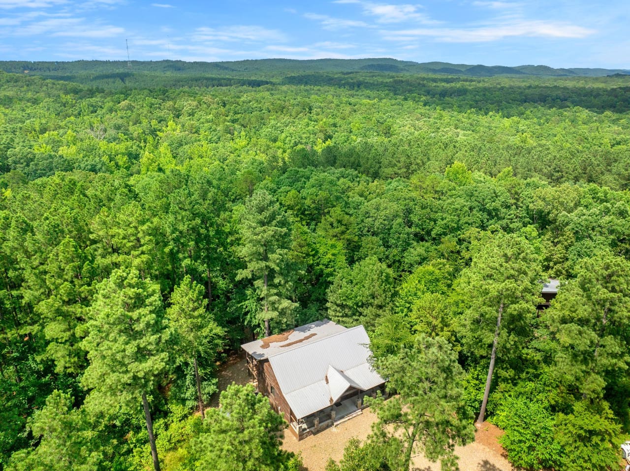 Stunning drone view shows off the surrounding beauty and cabin location.