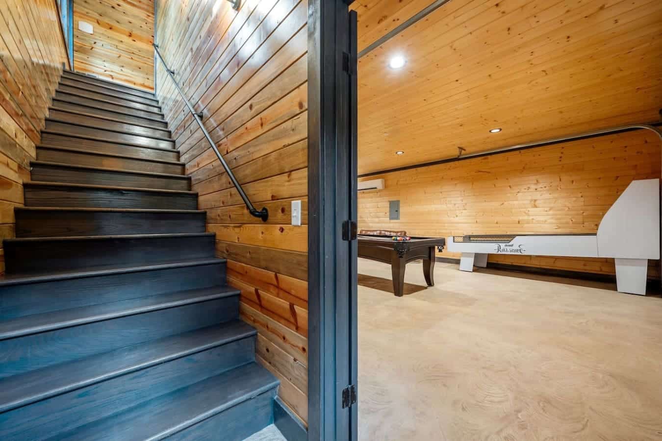 Downstairs fun, upstairs comfort this cabin flows with good vibes.