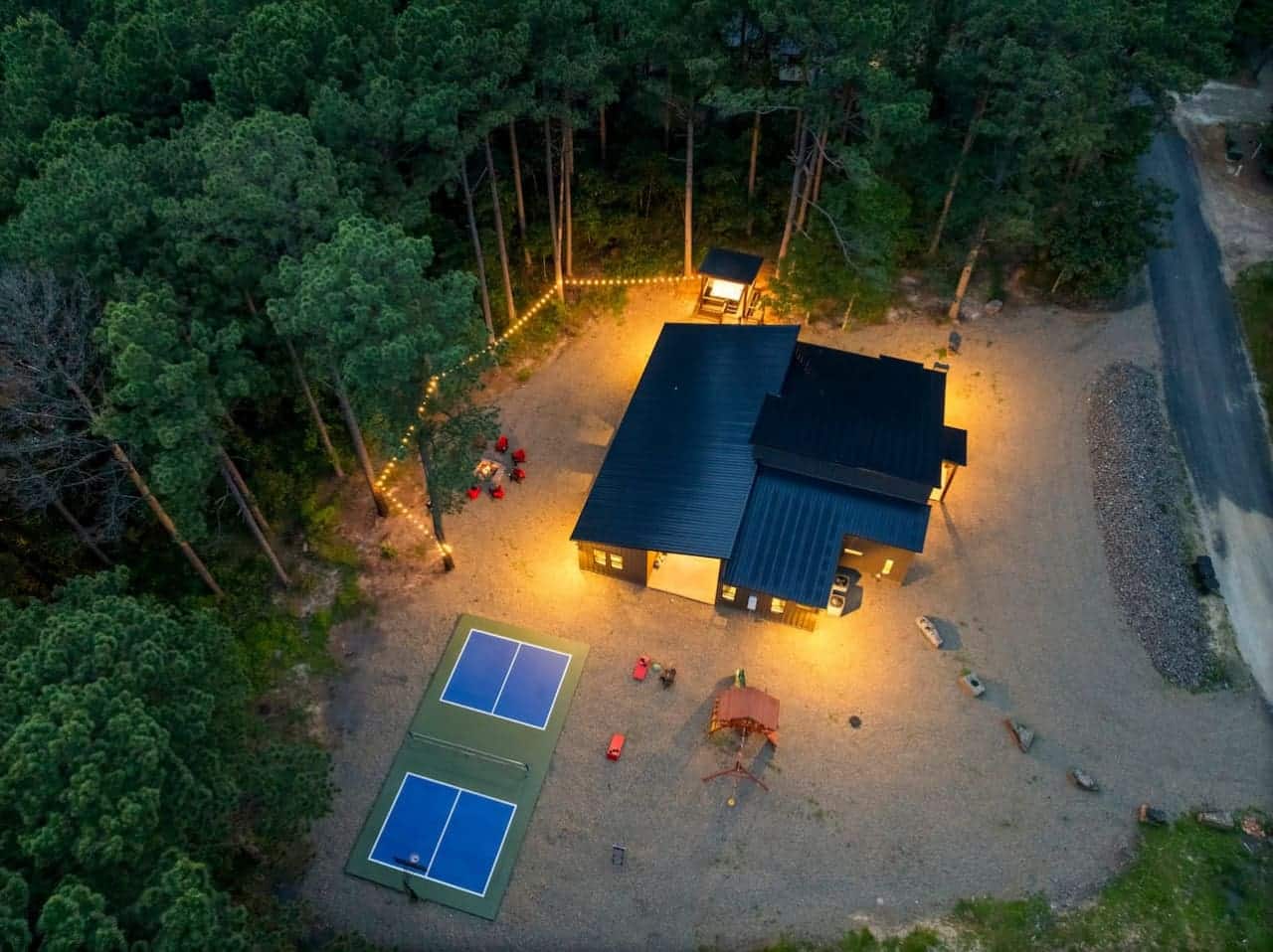 String lights, cozy fire-side seating, and a modern cabin lit just right.