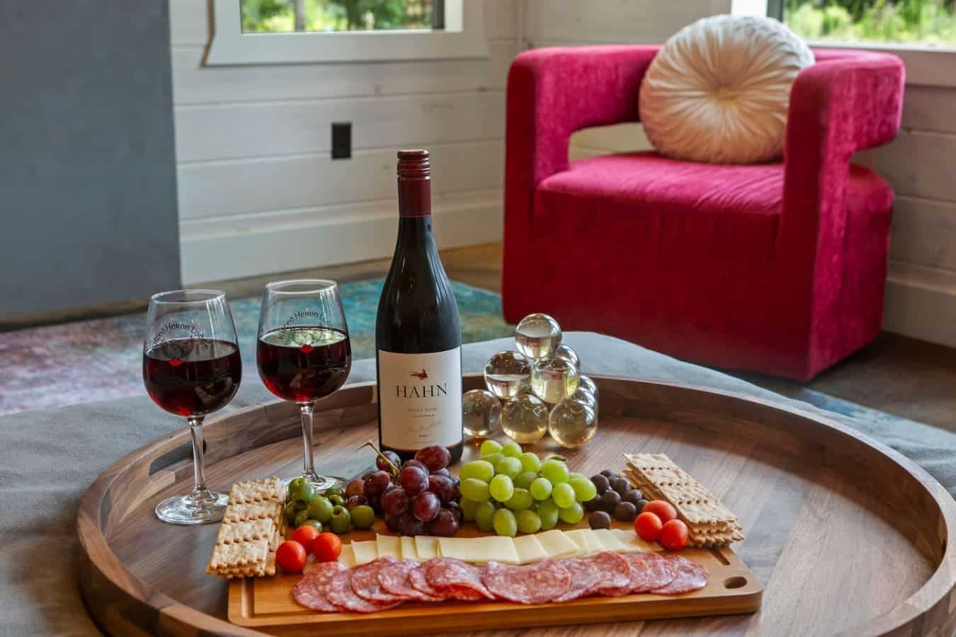 Sip wine, savor a charcuterie board, and sink into plush comforts surrounded by peaceful, rustic elegance.